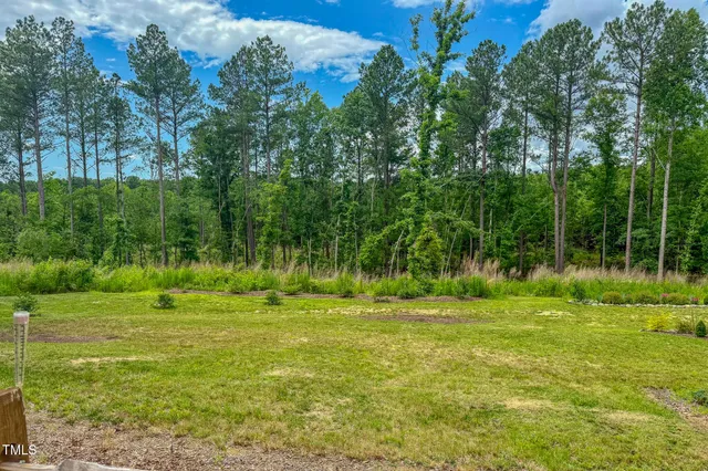 a view of an empty room with window and closet