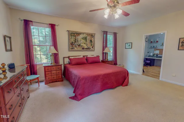 a bedroom with a bed dresser and window