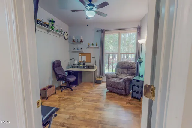a view of a backyard with plants and large trees