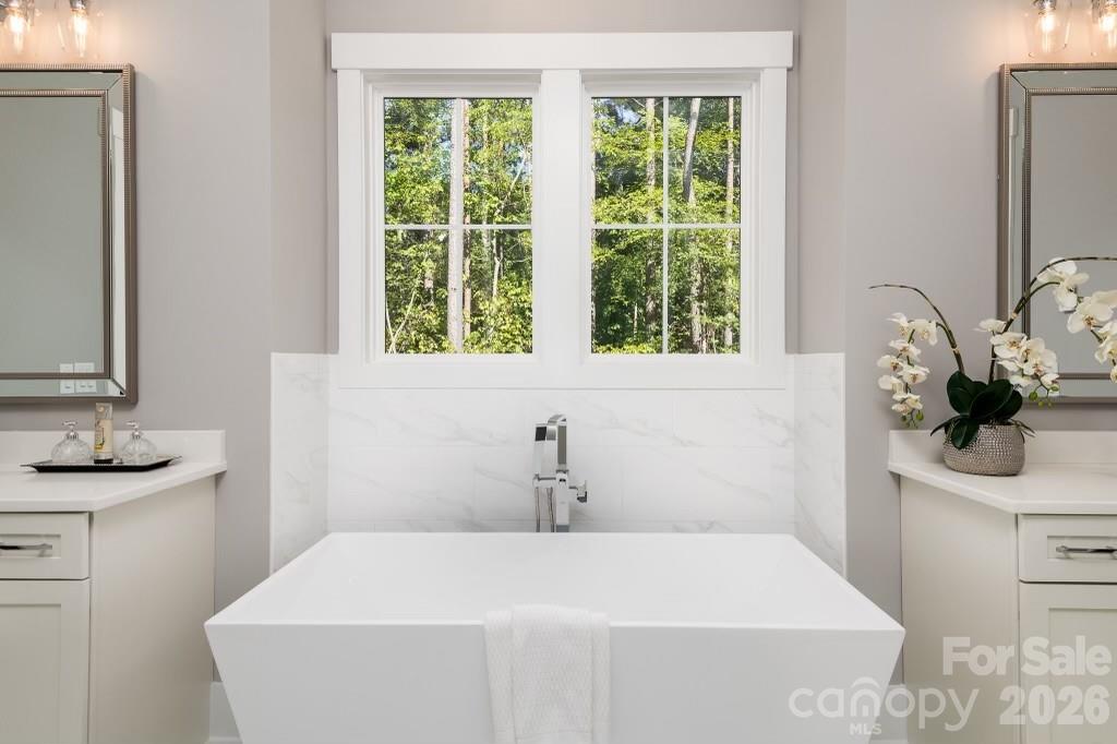 116 Silver Falls Road Troutman, NC 28166 - Photo 31 of 46 a bathroom with a sink and a mirror