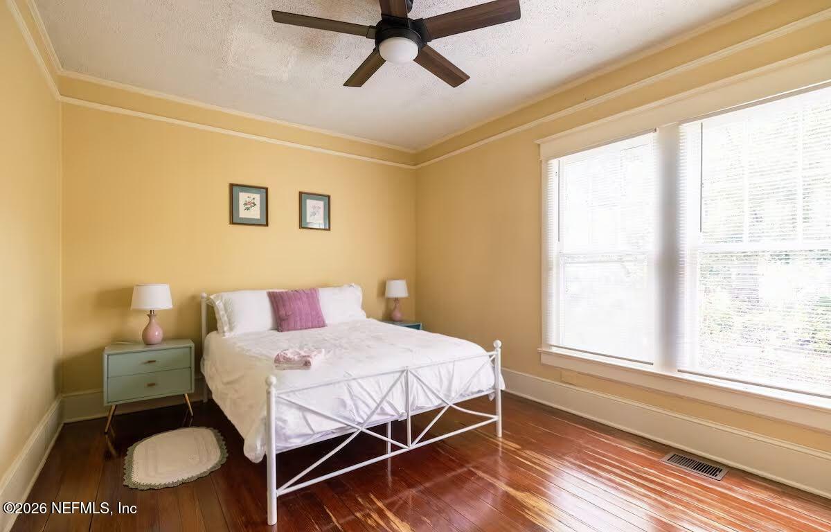 1438 Dancy Street Jacksonville, FL 32205 - Photo 17 of 49 a bedroom with a bed and wooden floor