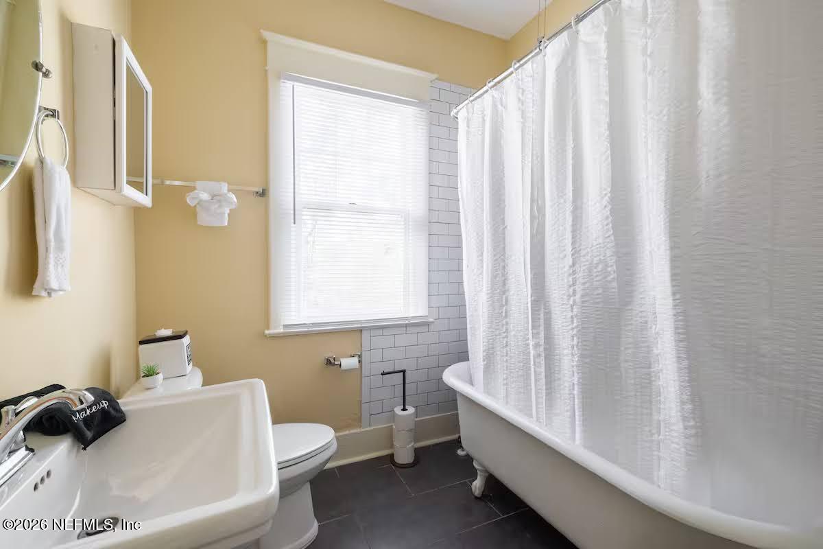 1438 Dancy Street Jacksonville, FL 32205 - Photo 19 of 49 a bathroom with a toilet a sink and a bathtub