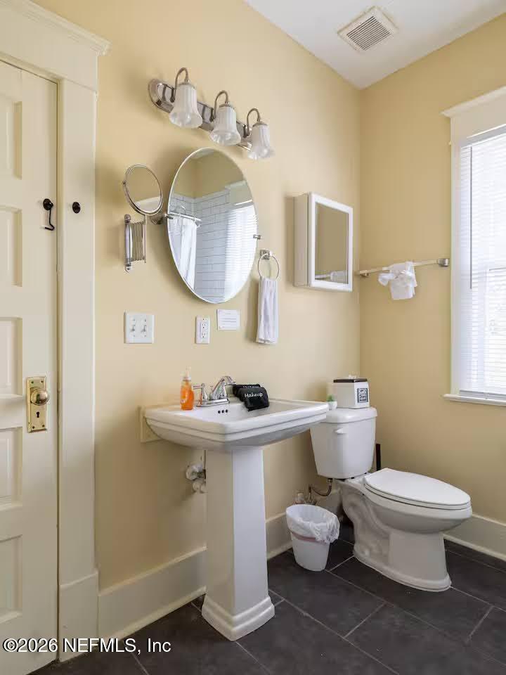 1438 Dancy Street Jacksonville, FL 32205 - Photo 20 of 49 a bathroom with a toilet sink and mirror
