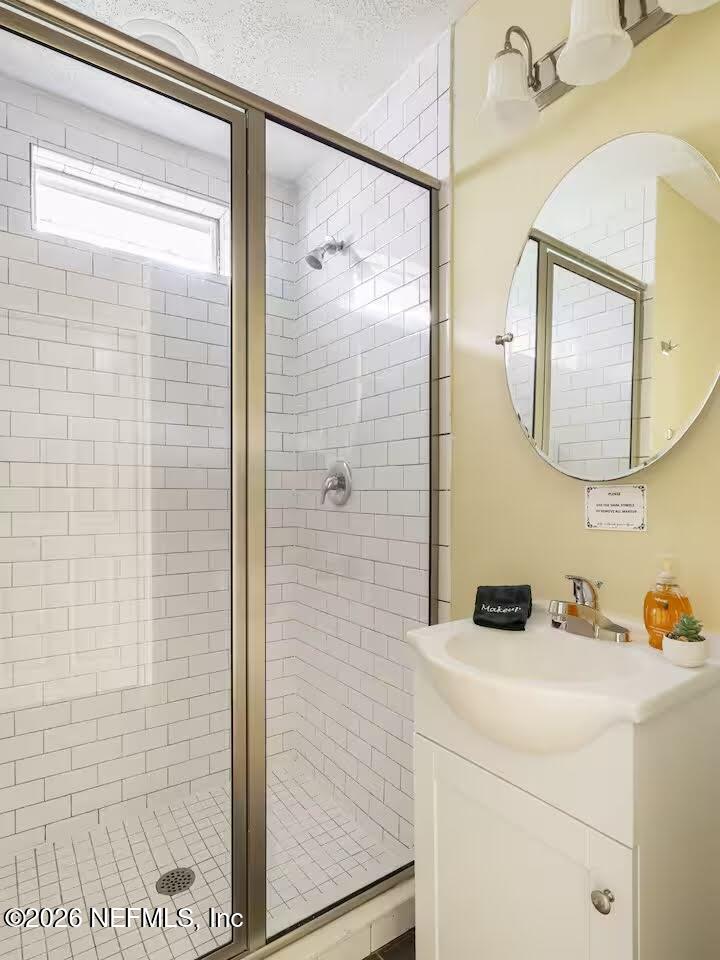 1438 Dancy Street Jacksonville, FL 32205 - Photo 22 of 49 a bathroom with a shower and a sink a mirror