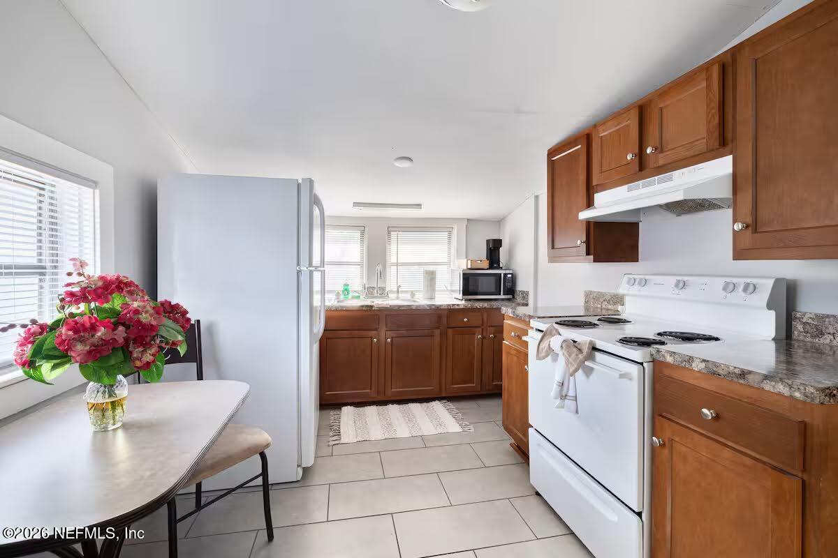 1438 Dancy Street Jacksonville, FL 32205 - Photo 23 of 49 a kitchen with stainless steel appliances granite countertop a stove top oven a sink dishwasher and cabinets with wooden floor