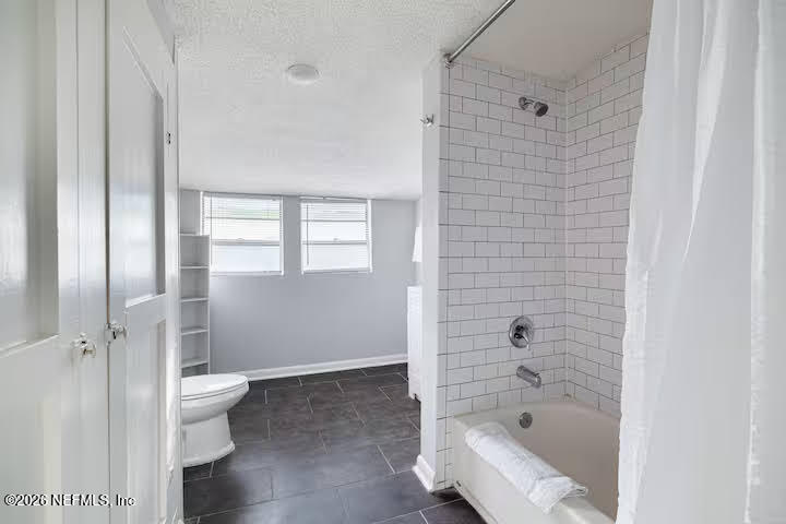 1438 Dancy Street Jacksonville, FL 32205 - Photo 29 of 49 a bathroom with a bathtub and toilet
