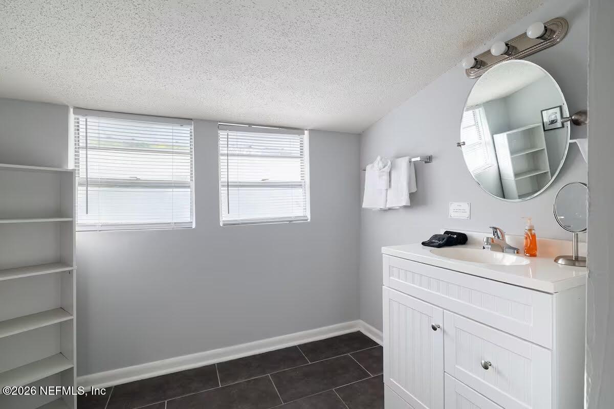 1438 Dancy Street Jacksonville, FL 32205 - Photo 30 of 49 a bathroom with a sink a mirror and vanity