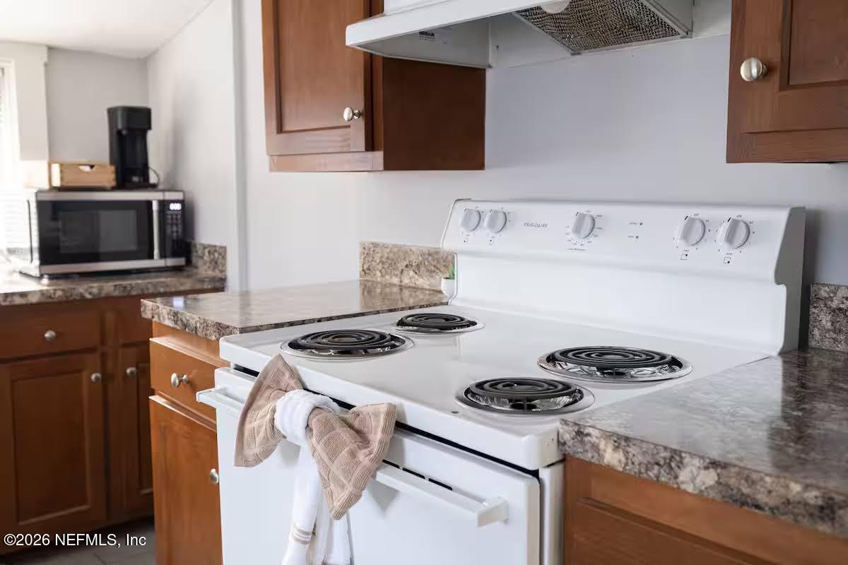 1438 Dancy Street Jacksonville, FL 32205 - Photo 31 of 49 a kitchen with a stove and a microwave