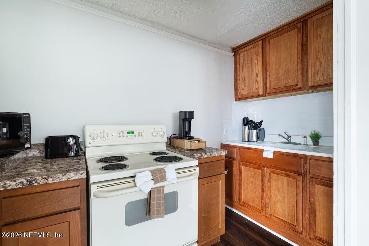1438 Dancy Street Jacksonville, FL 32205 - Photo 39 of 49 a kitchen with stainless steel appliances granite countertop a stove a sink and a refrigerator