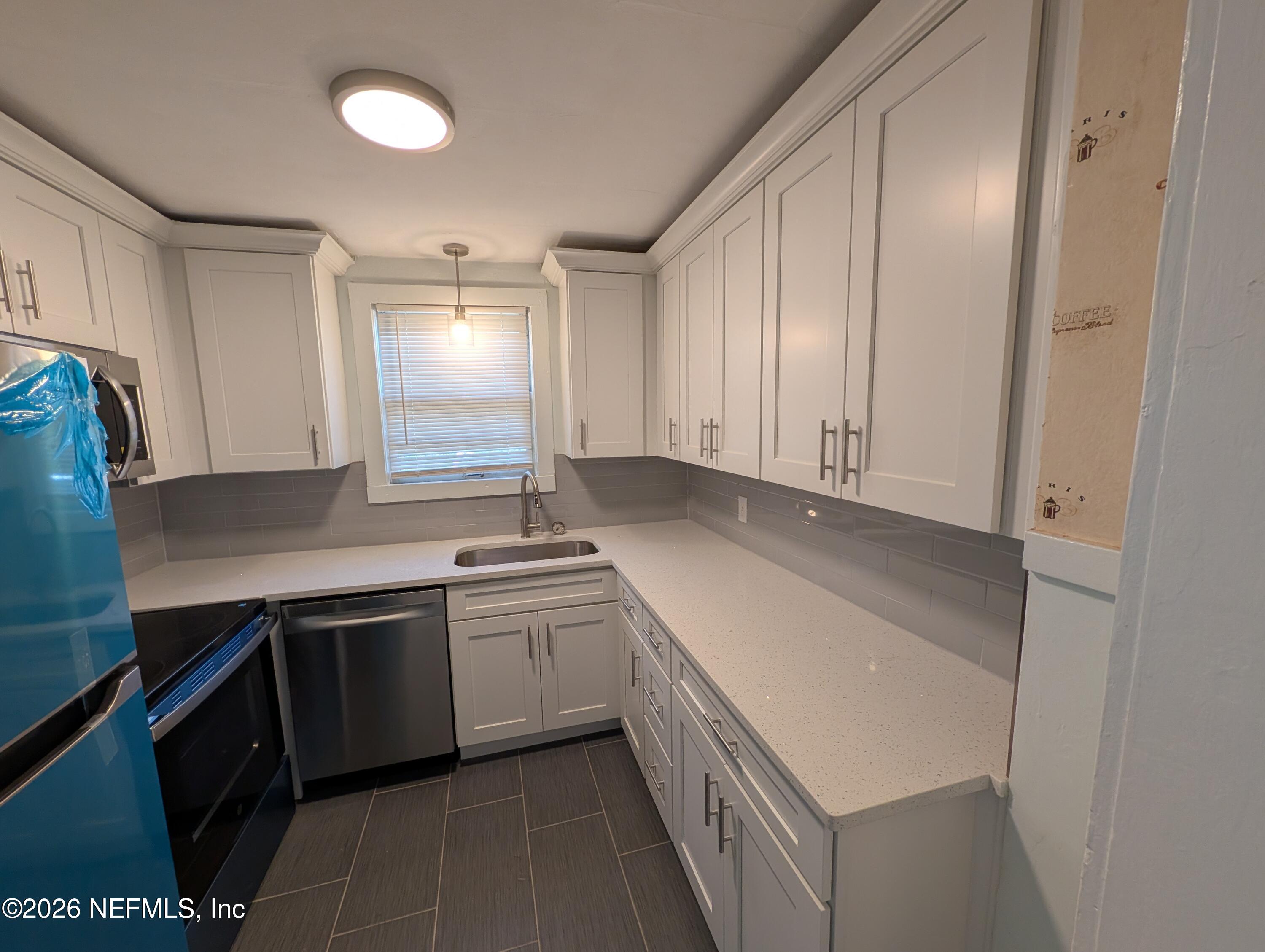 1438 Dancy Street Jacksonville, FL 32205 - Photo 45 of 49 a kitchen with a sink and cabinets