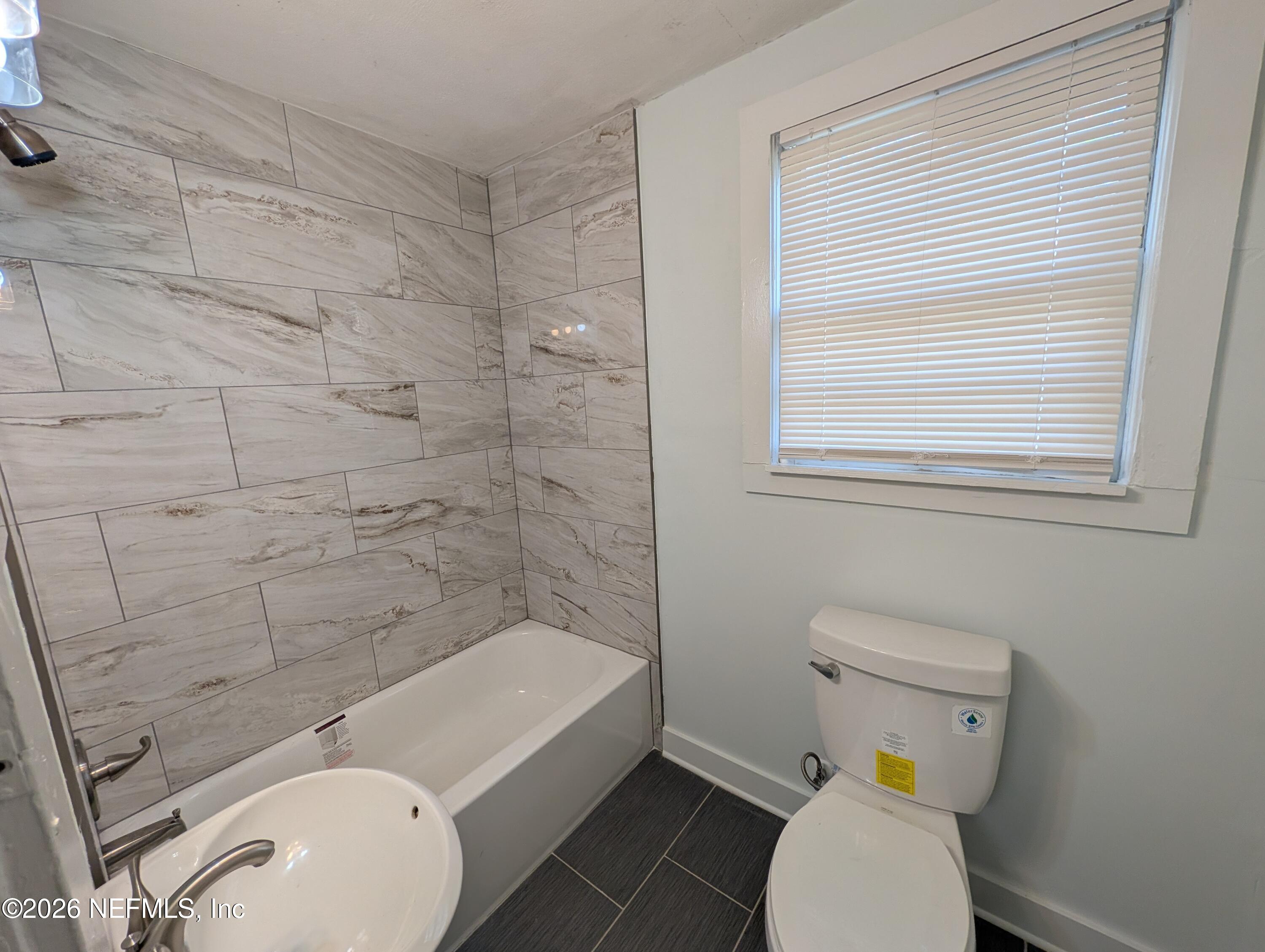 1438 Dancy Street Jacksonville, FL 32205 - Photo 49 of 49 a bathroom with a sink toilet and shower