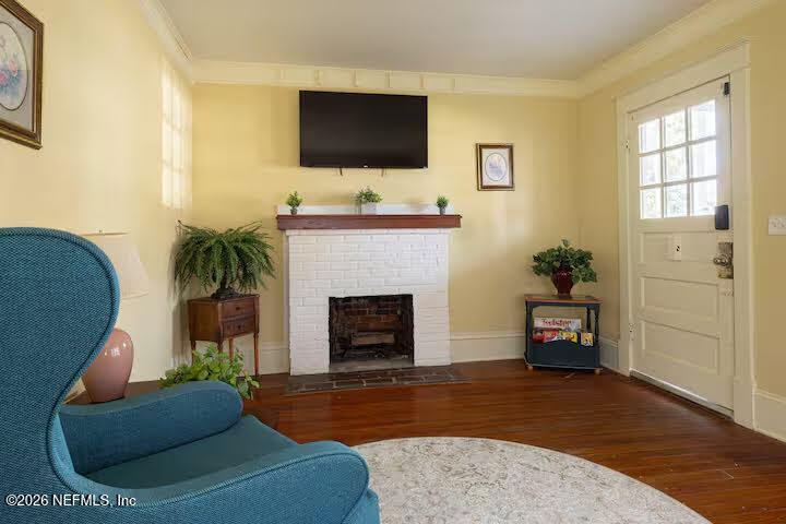 1438 Dancy Street Jacksonville, FL 32205 - Photo 10 of 49 a living room with furniture a fireplace and a flat screen tv