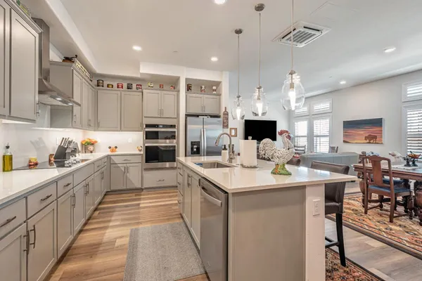 a kitchen with stainless steel appliances kitchen island granite countertop a sink and cabinets