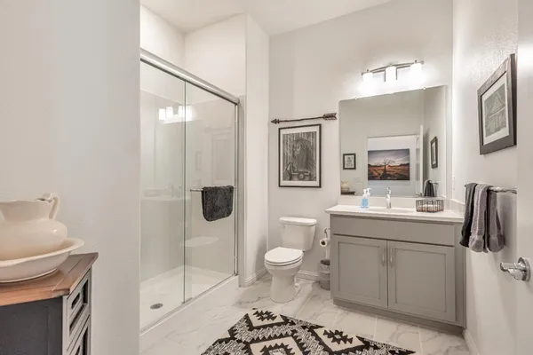 a bathroom with a toilet a sink and shower