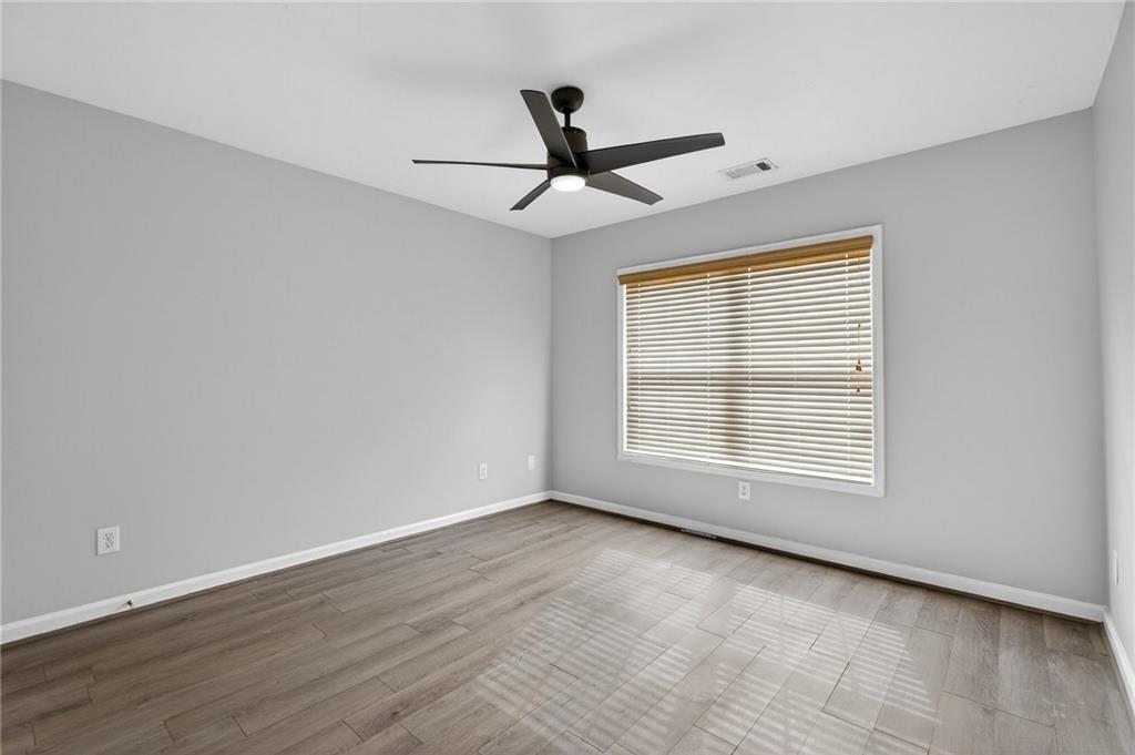 103 Forest Creek Way Canton, GA 30115 - Photo 44 of 55 a view of an empty room with wooden floor and a window