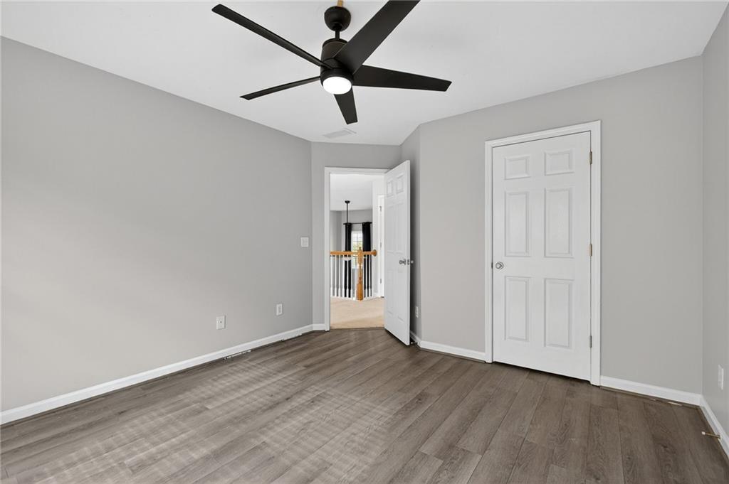103 Forest Creek Way Canton, GA 30115 - Photo 45 of 55 an empty room with wooden floor and windows