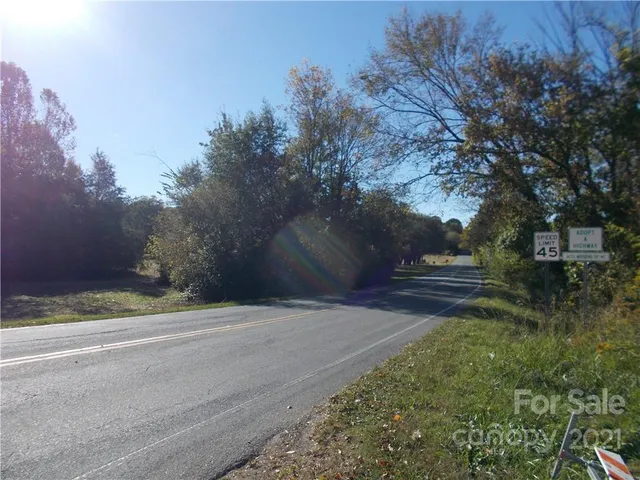 a view of mountain with beach and green space