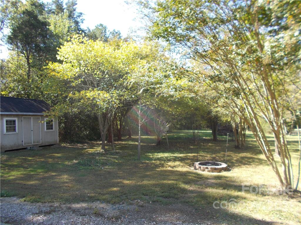 109 Brief Road West Fairview, NC 28079 - Photo 8 of 16 a backyard of a house with lots of green space