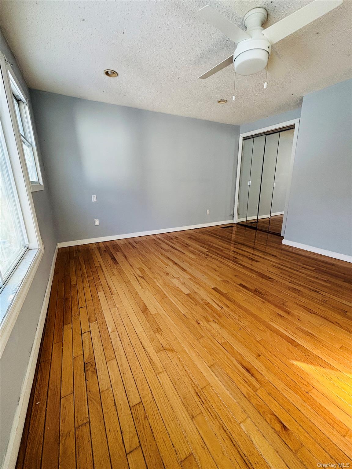 929 Fox Meadow Road Yorktown Heights, NY 10598 - Photo 12 of 41 wooden floor in an empty room with a window