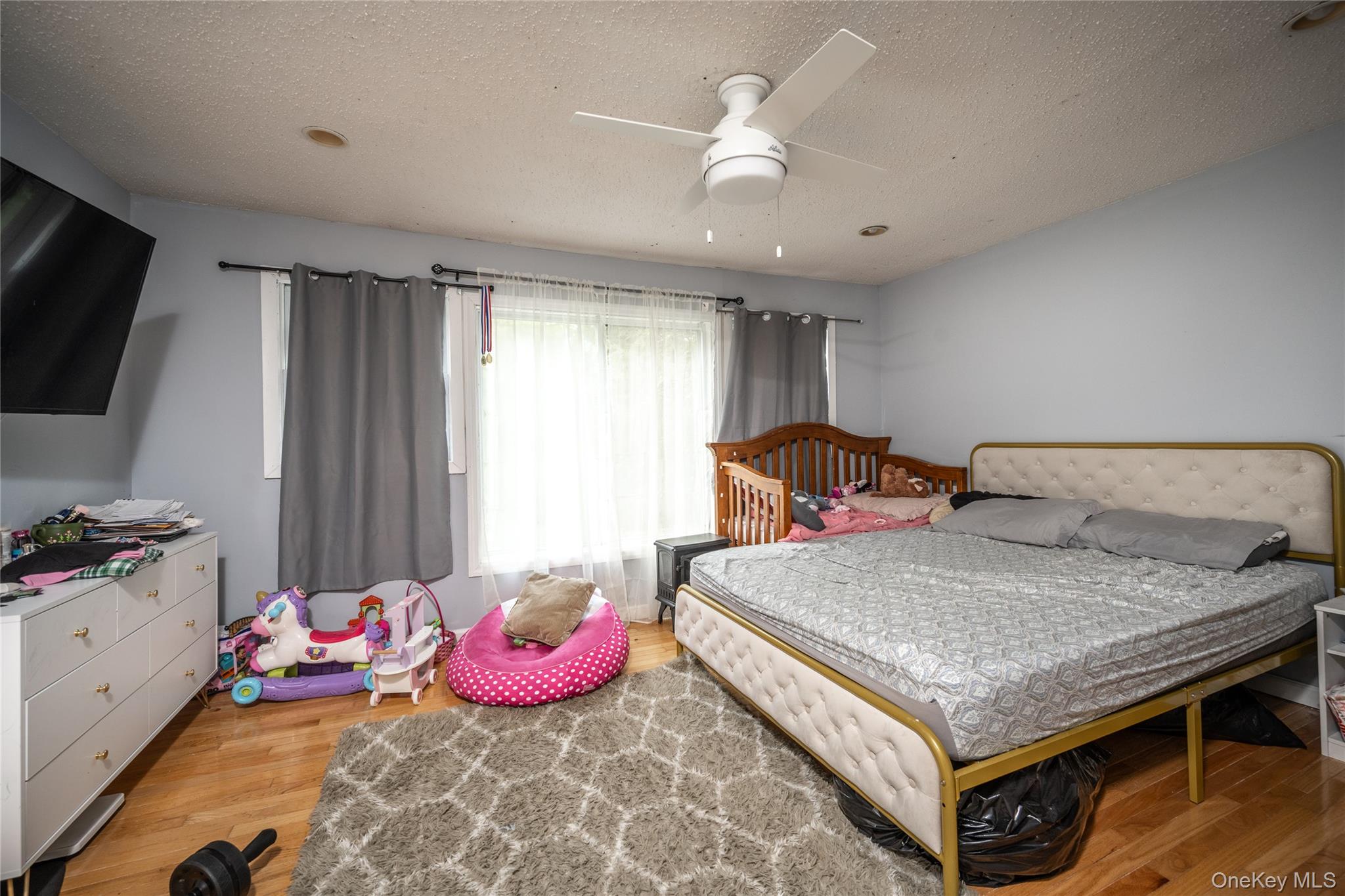 929 Fox Meadow Road Yorktown Heights, NY 10598 - Photo 13 of 32 a bedroom with a bed and a chandelier