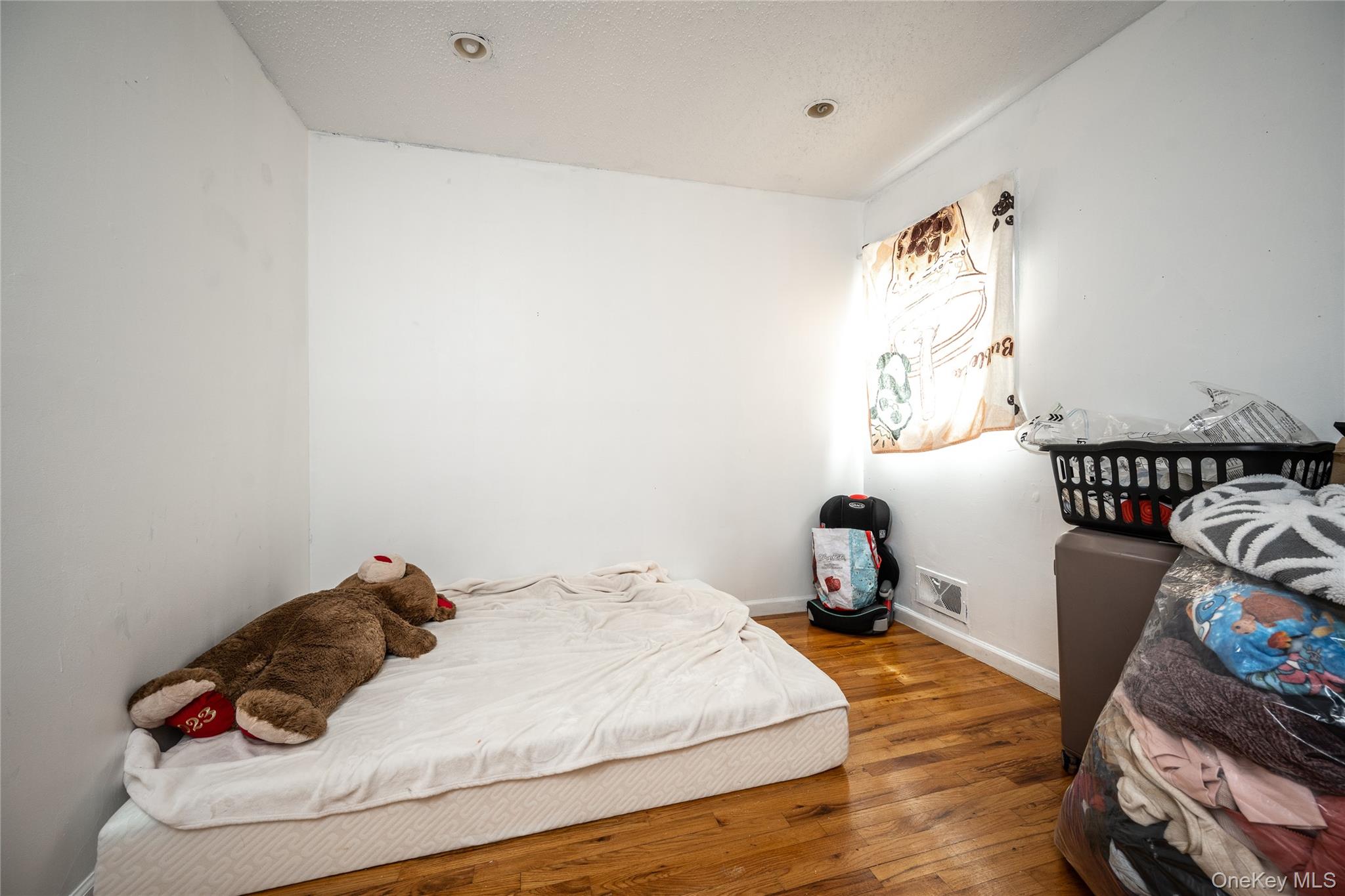 929 Fox Meadow Road Yorktown Heights, NY 10598 - Photo 16 of 32 a bedroom with a bed and wooden floor