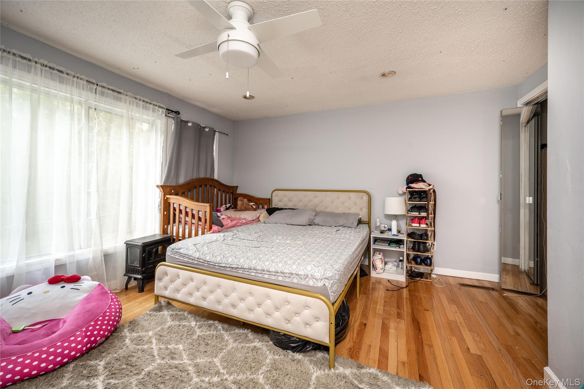 929 Fox Meadow Road Yorktown Heights, NY 10598 - Photo 17 of 32 a bedroom with a bed and a chandelier