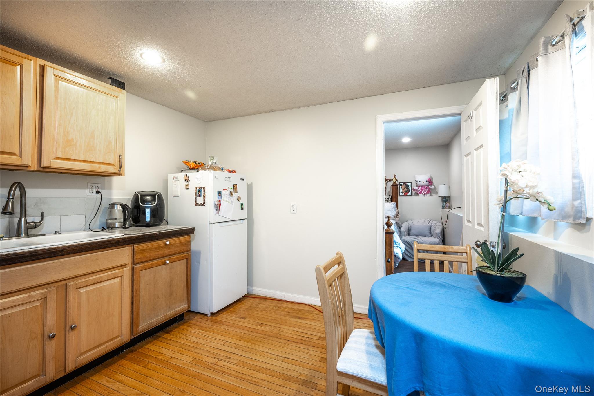 929 Fox Meadow Road Yorktown Heights, NY 10598 - Photo 19 of 32 a kitchen with sink cabinets and wooden floor
