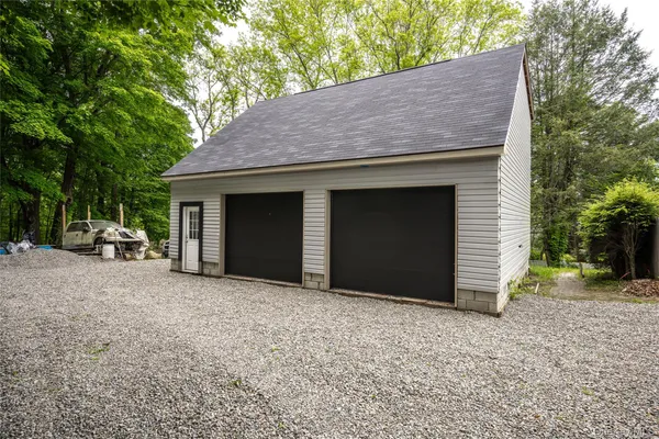 a front view of a house with a yard and trees