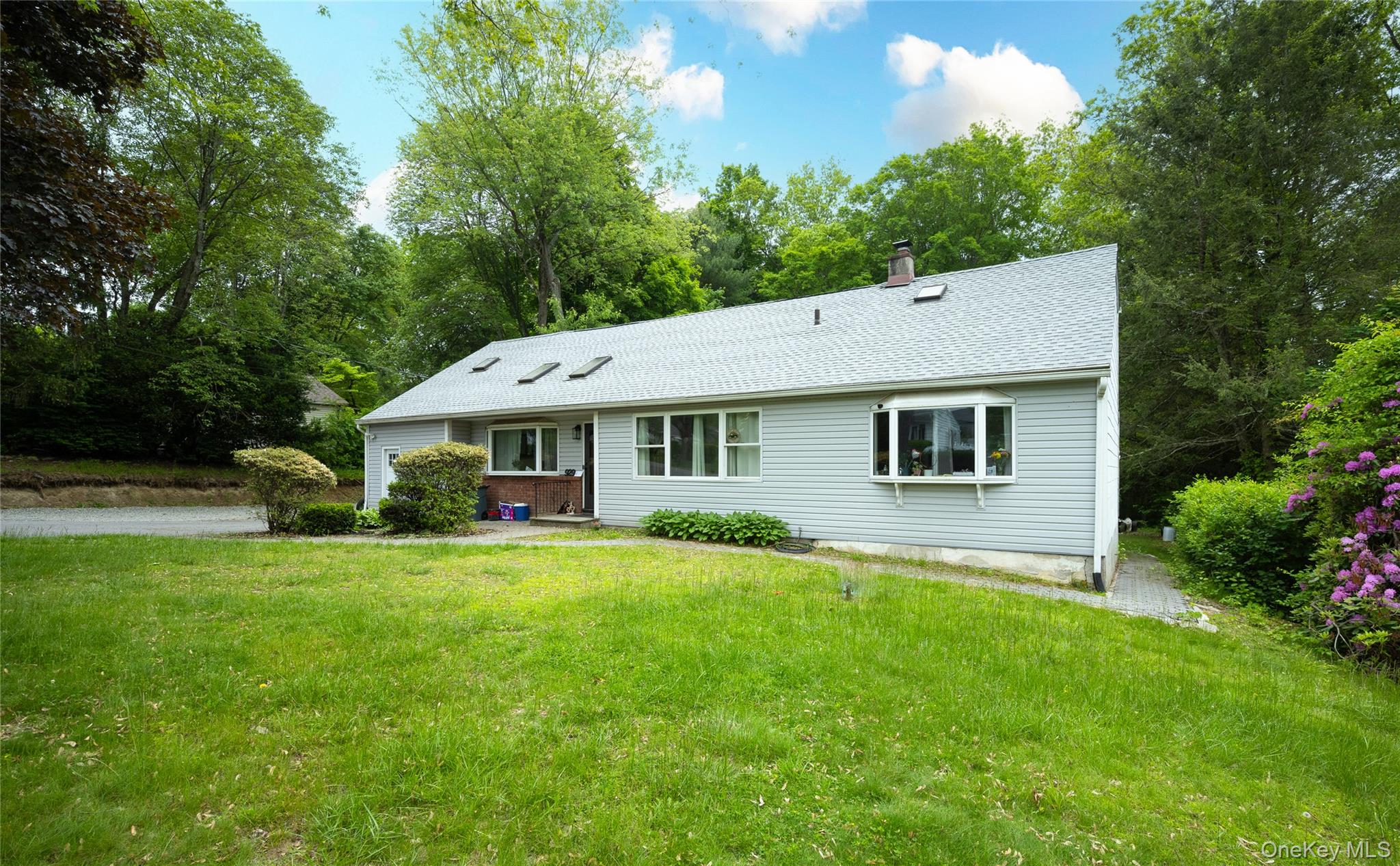 929 Fox Meadow Road Yorktown Heights, NY 10598 - Photo 31 of 41 View of front of property featuring a front yard, a chimney, and roof with shingles