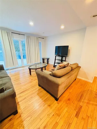 a kitchen with stainless steel appliances wooden floor and a sink