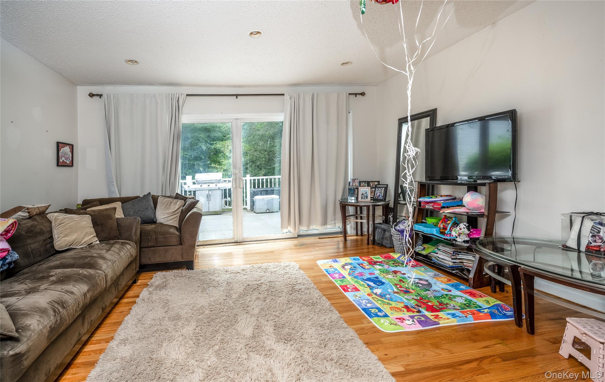929 Fox Meadow Road Yorktown Heights, NY 10598 - Photo 7 of 32 a living room with furniture and a flat screen tv