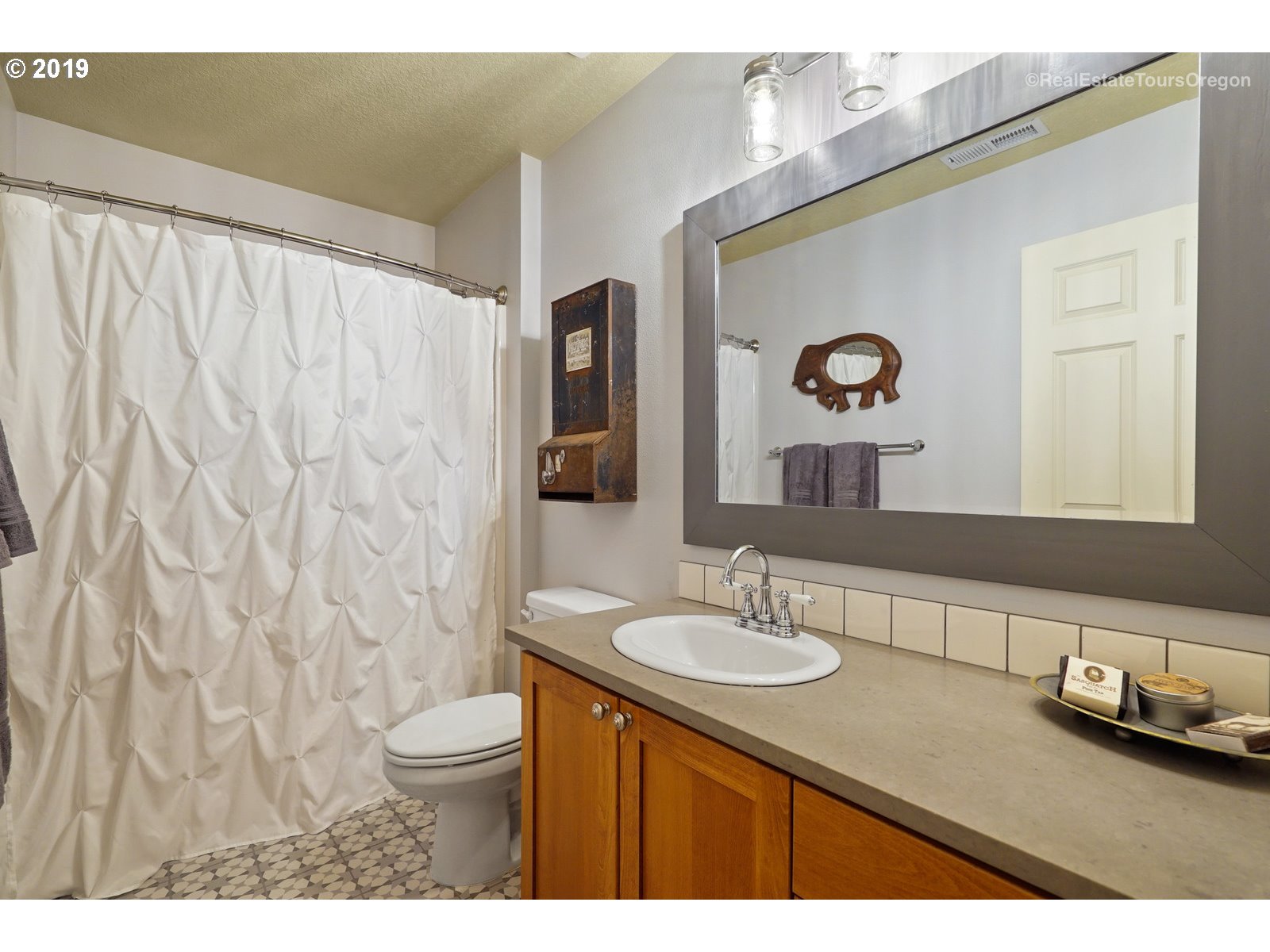 11909 Southeast Laughing Water Road Sandy, OR 97055 - Photo 11 of 22 a bathroom with a granite countertop sink and a mirror