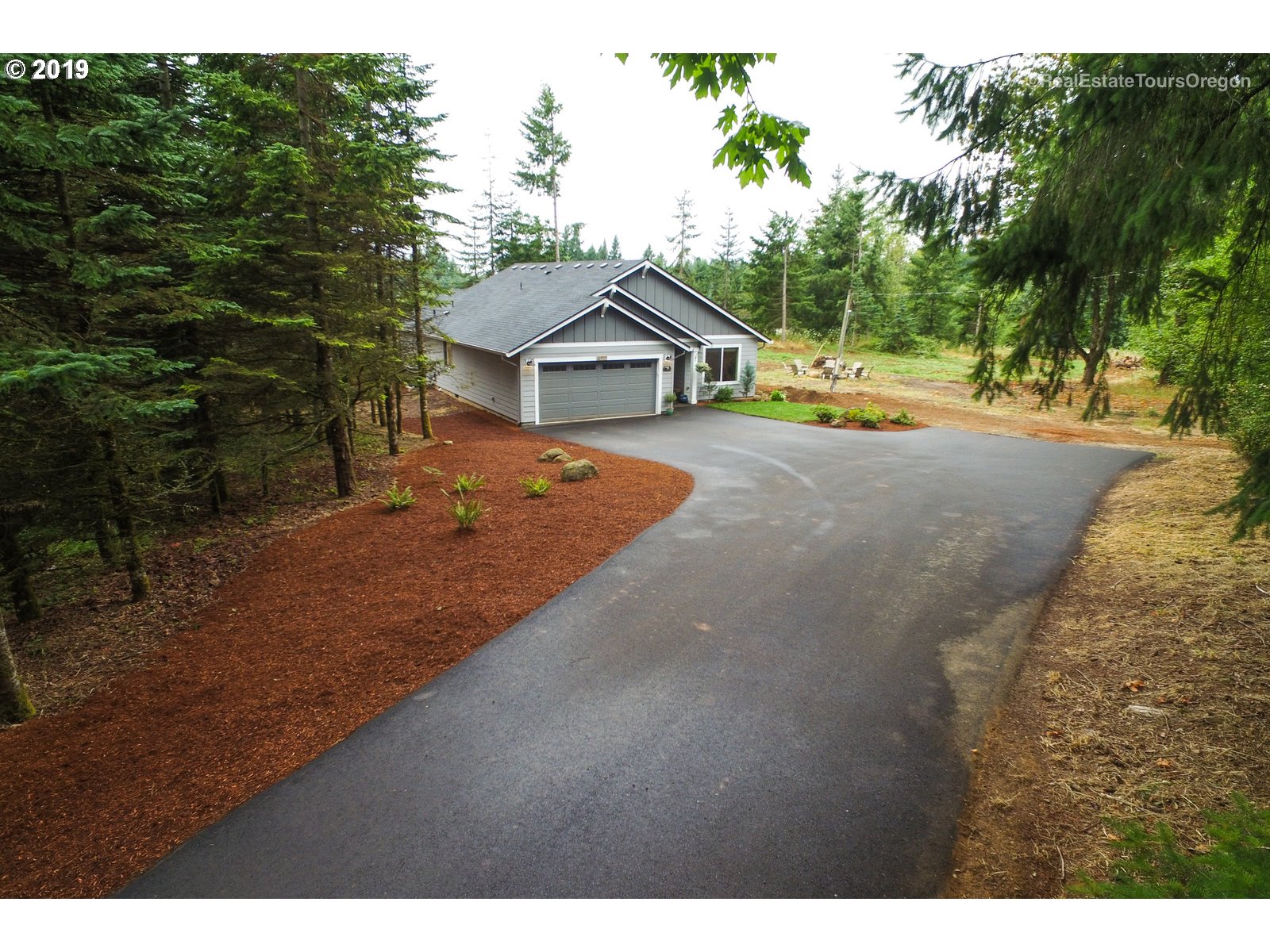 11909 Southeast Laughing Water Road Sandy, OR 97055 - Photo 18 of 22 a view of a house with a yard and large trees