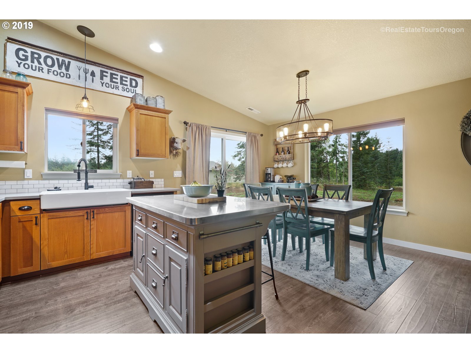 11909 Southeast Laughing Water Road Sandy, OR 97055 - Photo 4 of 22 a kitchen with a wooden cabinets and dining table