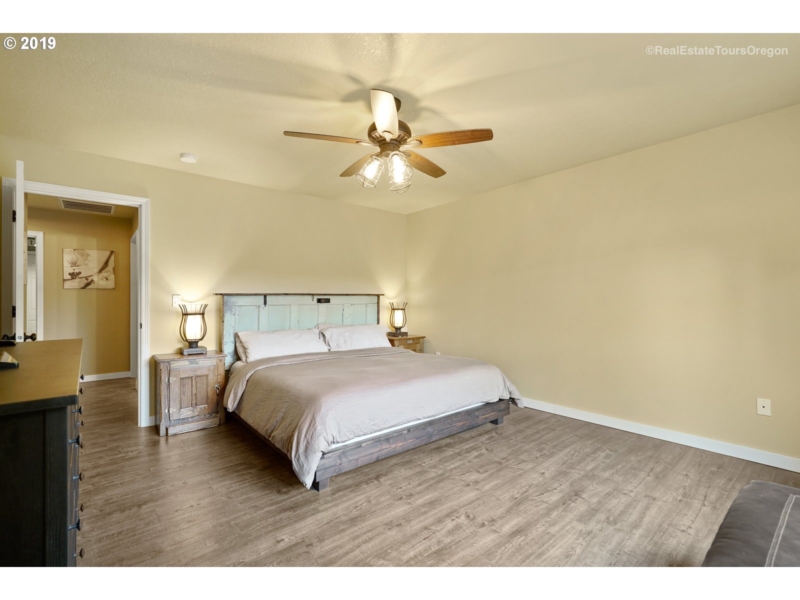11909 Southeast Laughing Water Road Sandy, OR 97055 - Photo 7 of 22 a bedroom with a bed and wooden floor