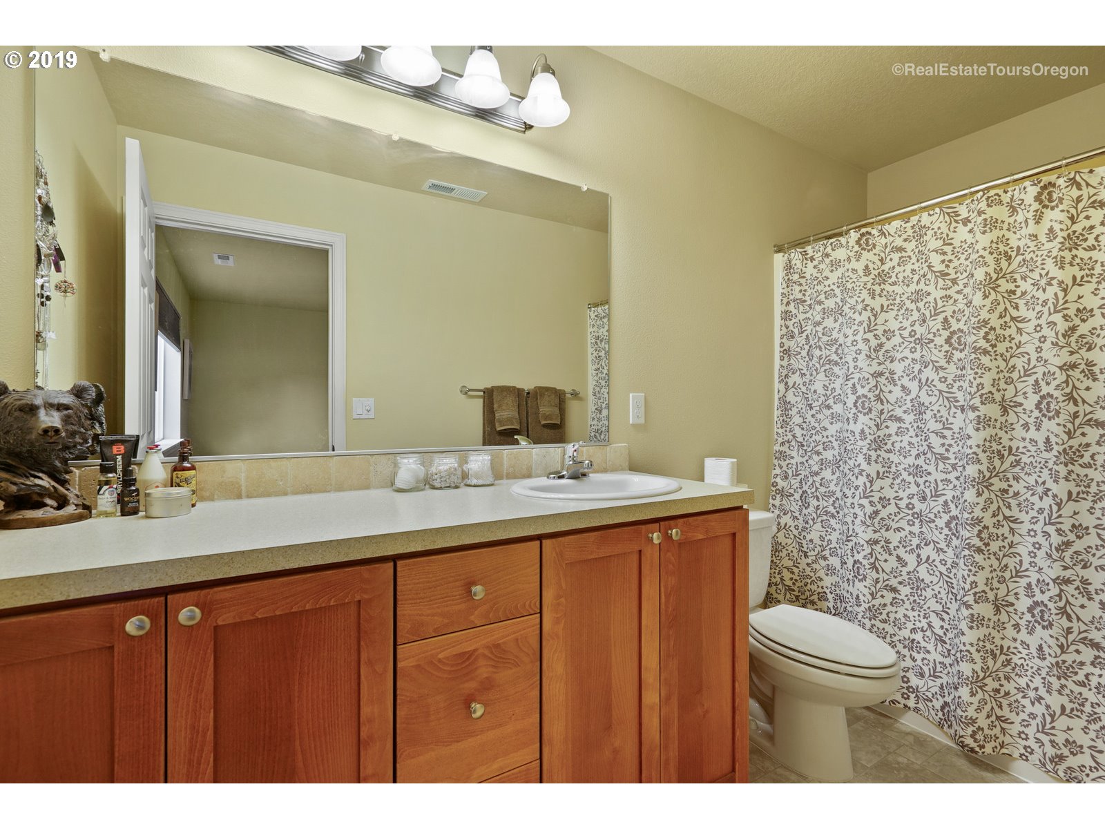 11909 Southeast Laughing Water Road Sandy, OR 97055 - Photo 8 of 22 a bathroom with a granite countertop sink toilet a mirror and shower