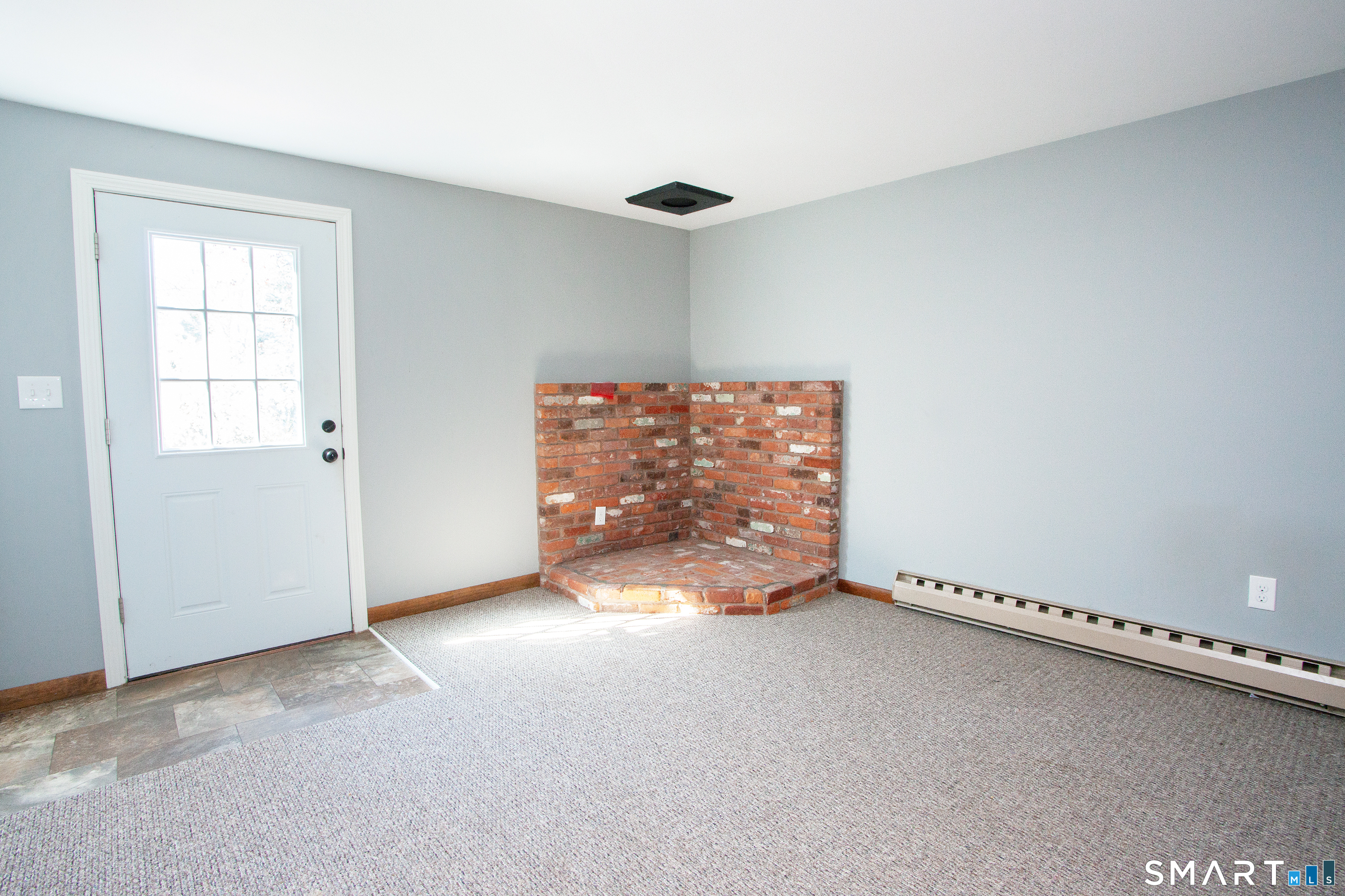 172 Weymouth Road Enfield, CT 06082 - Photo 15 of 35 Previous owners may have had a wood stove in the brick area. Door leads to patio and the back yard