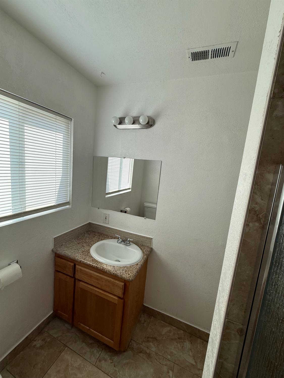 501 Rotan Avenue Madera, CA 93637 - Photo 8 of 23 a bathroom with a sink and a mirror