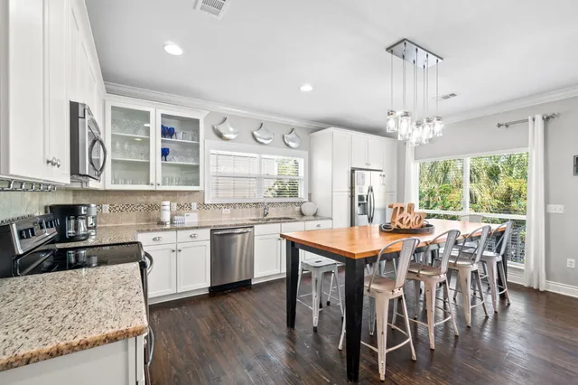 a kitchen with granite countertop white cabinets and white appliances