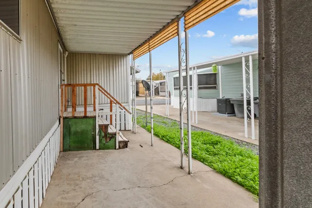 a view of a house with wooden floor and fence