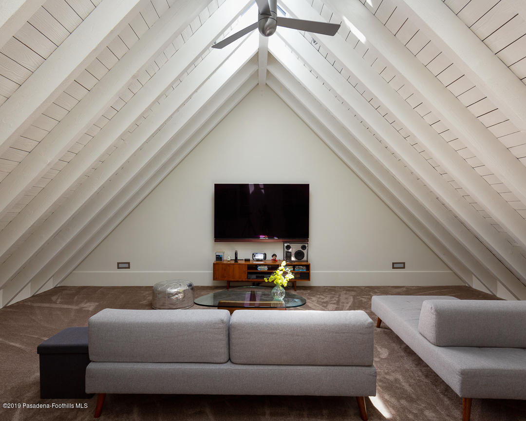 561 Woodland Road Pasadena, CA 91106 - Photo 17 of 41 a living room with furniture and a flat screen tv
