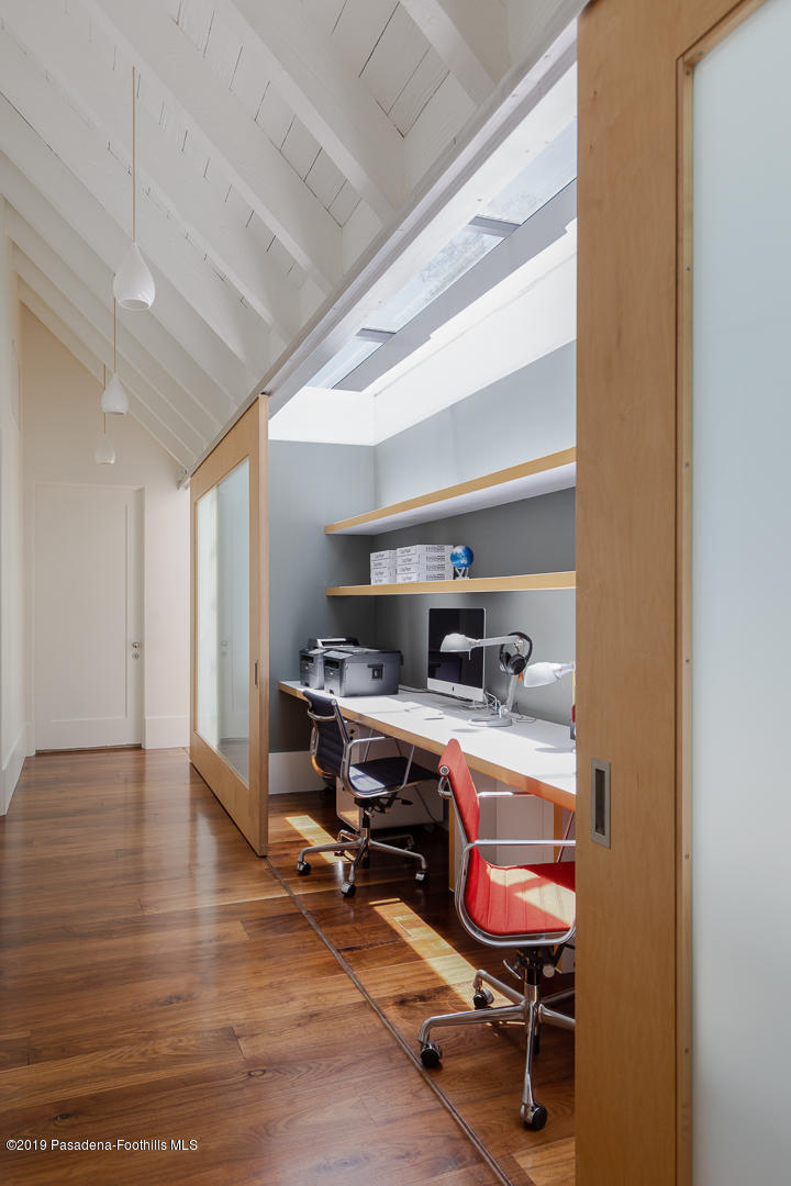561 Woodland Road Pasadena, CA 91106 - Photo 20 of 41 a view of a workspace with furniture and a window