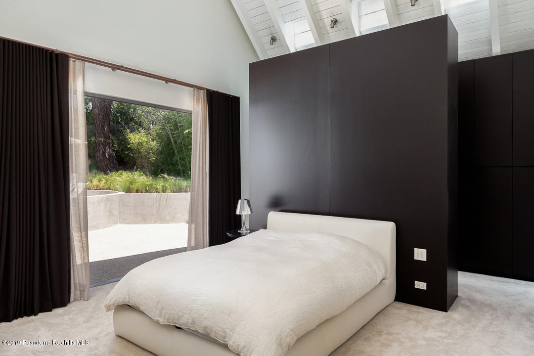 561 Woodland Road Pasadena, CA 91106 - Photo 24 of 41 a bedroom with a bed and window