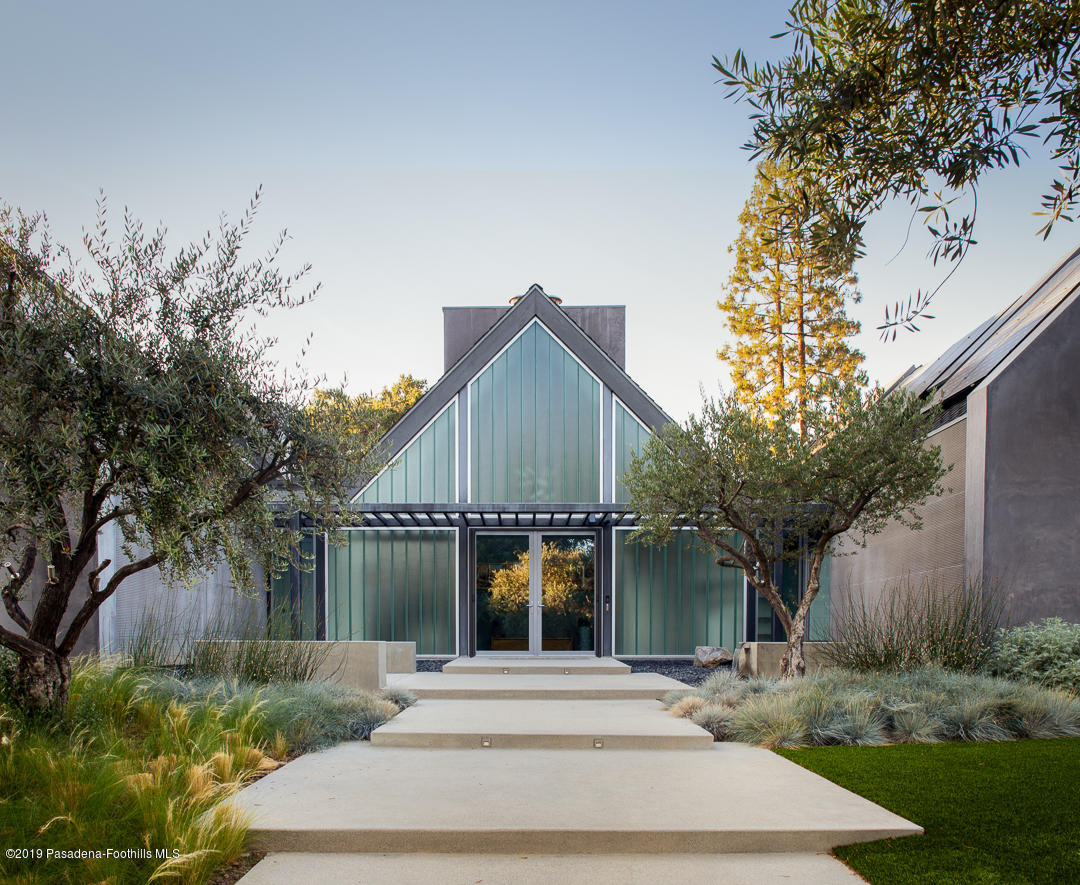 561 Woodland Road Pasadena, CA 91106 - Photo 3 of 41 a front view of a house with a yard and trees