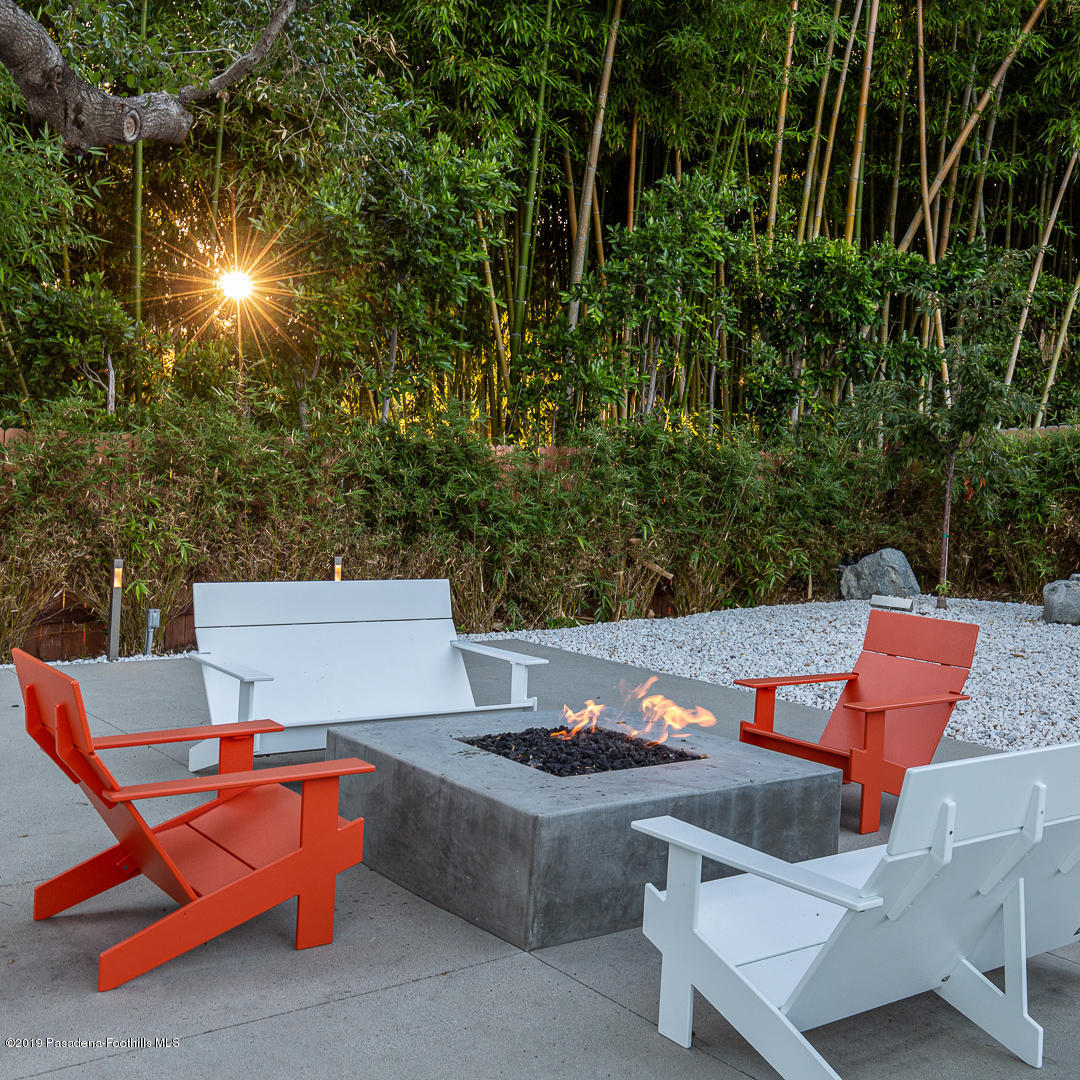 561 Woodland Road Pasadena, CA 91106 - Photo 35 of 41 a view of a patio with a table and chairs