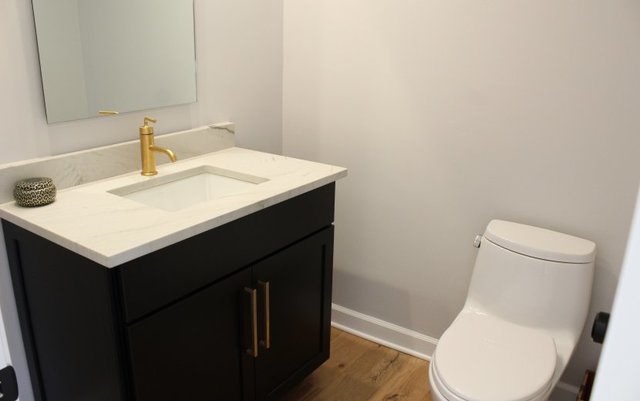 1720 Ridgewood Lane East Glenview, IL 60025 - Photo 20 of 24 a bathroom with a sink and a toilet