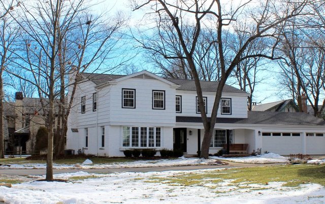 1720 Ridgewood Lane East Glenview, IL 60025 - Photo 3 of 24 a front view of a house with large trees and a forest