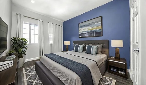 a bed sitting in a bedroom next to a window