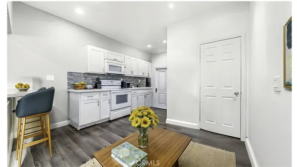 a kitchen with refrigerator cabinets and wooden floor