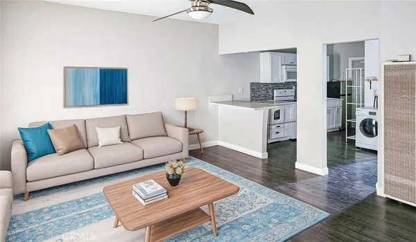 a living room with furniture and wooden floor
